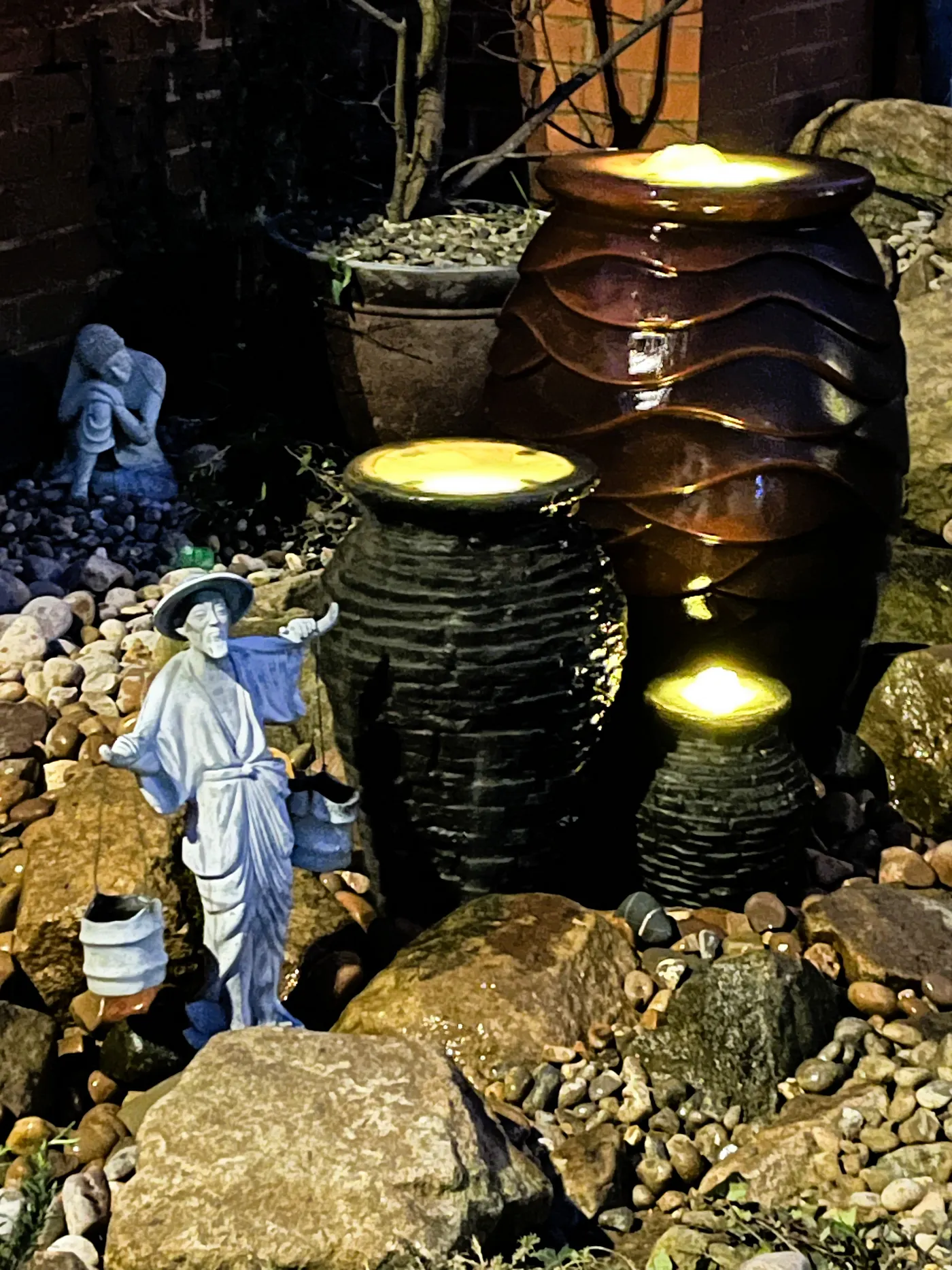 Decorative urn water feature with flowing water in a landscaped garden